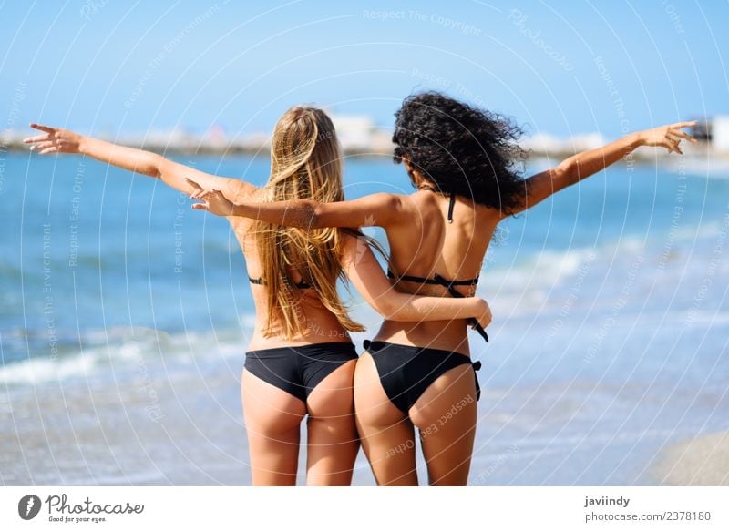 Two young women in bikini having fun on a tropical beach Lifestyle Joy Happy Beautiful Body Leisure and hobbies Vacation & Travel Tourism Summer Beach Ocean