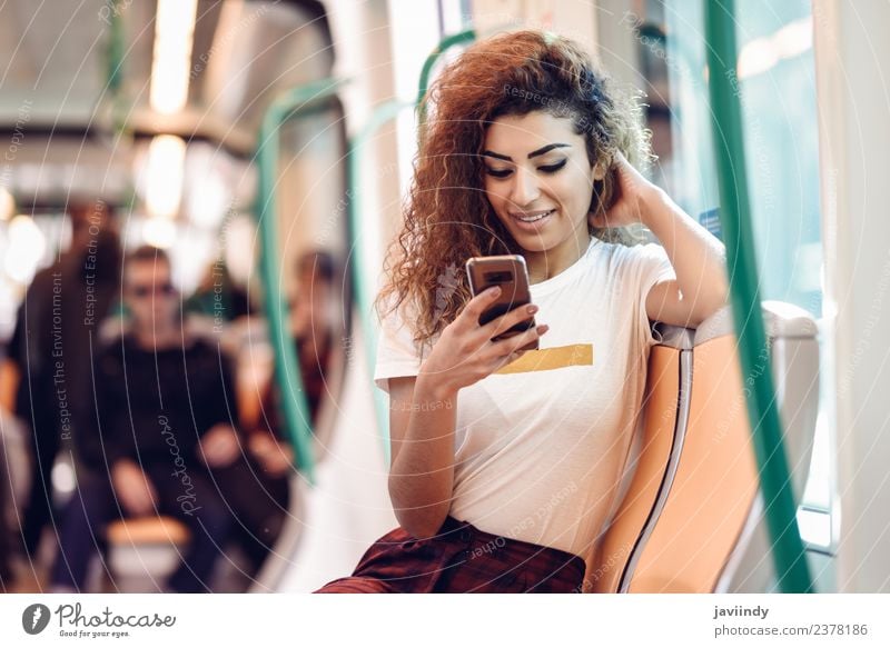 Woman inside subway train looking at her smart phone. Lifestyle Happy Beautiful Hair and hairstyles Vacation & Travel Tourism Trip Telephone PDA Human being