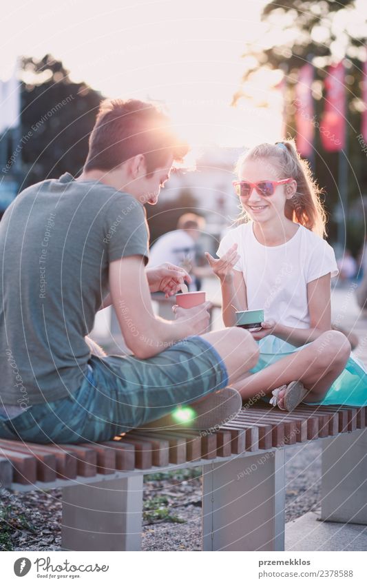 Young girl and boy spending time together in the city centre Dessert Ice cream Eating Lifestyle Joy Happy Leisure and hobbies Vacation & Travel Summer