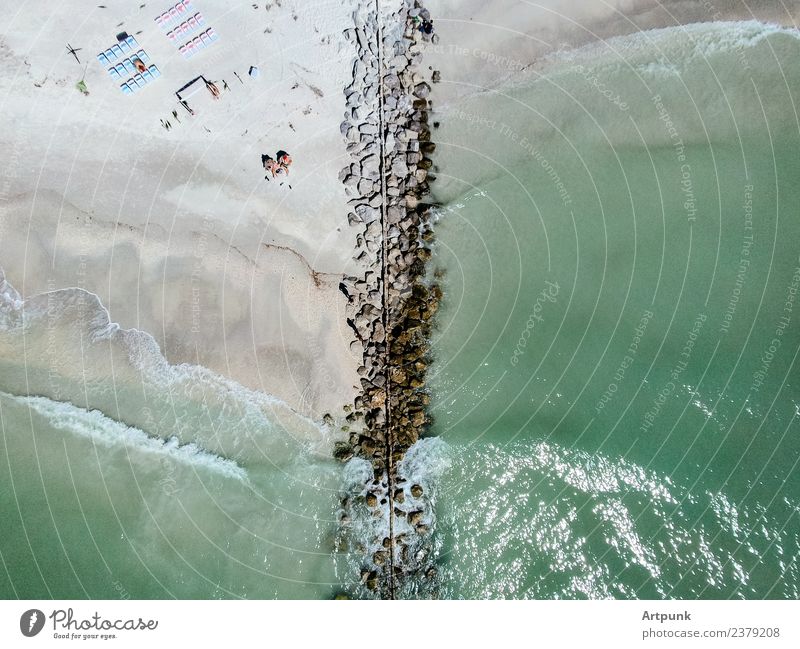 Aerial view of a jetty Jetty Water Waves Ocean Aircraft Vantage point Drone Summer Beach Chair Human being Green Sand Sun Rock Stone block Bikini