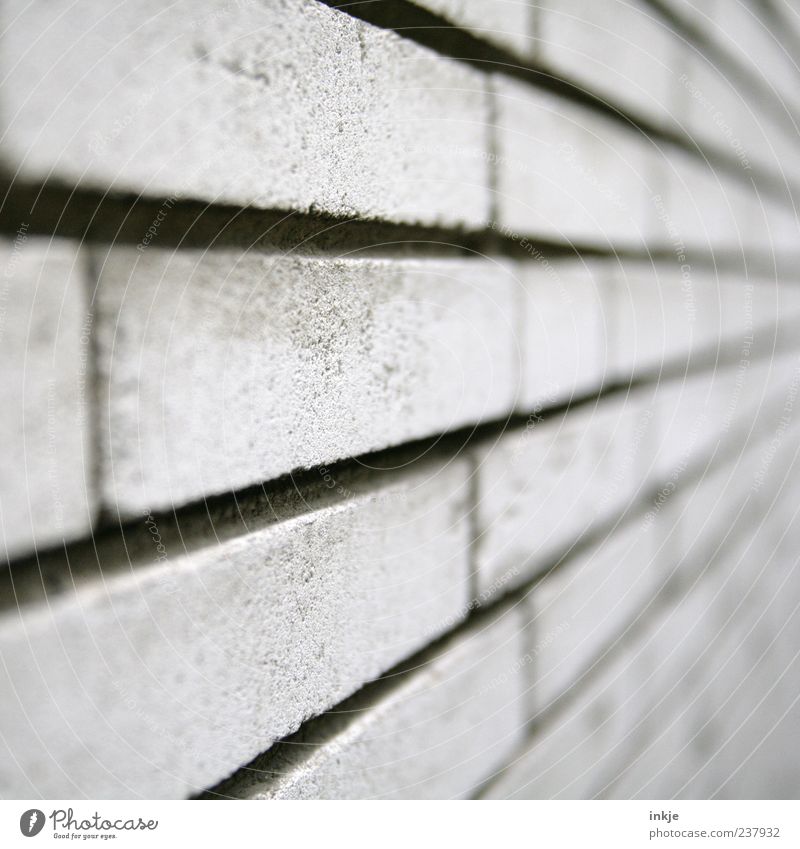 always on the wall long Wall (barrier) Wall (building) Facade Sandstone Stone wall Concrete Brick Line Stripe Cold Gray Vanishing point Brick wall Colour photo