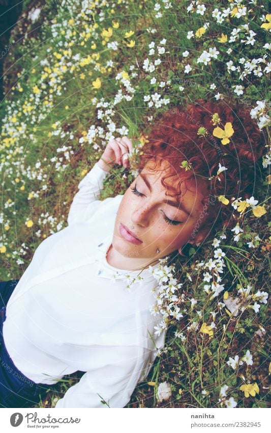 Young redhead woman sleeping in a field of flowers Lifestyle Elegant Beautiful Hair and hairstyles Skin Face Healthy Wellness Harmonious Well-being Senses