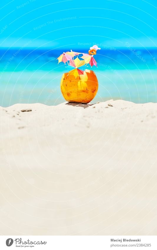 Coconut with colorful umbrellas and straws on a beach. Fruit Beverage Cold drink Lifestyle Luxury Joy Relaxation Vacation & Travel Tourism Summer