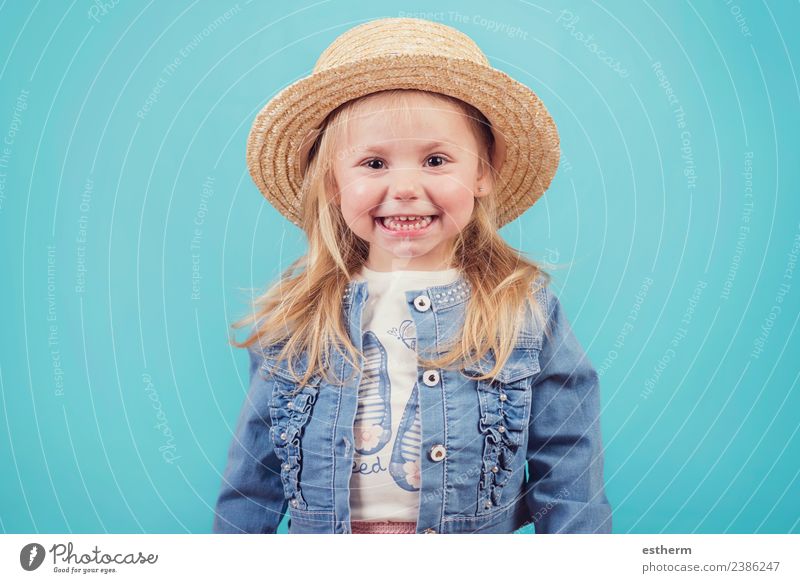 happy and smiling baby with hat on blue background Lifestyle Joy Human being Feminine Baby Girl Infancy 1 3 - 8 years Child Hat Fitness Smiling Laughter