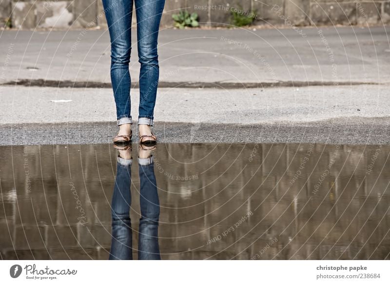 Twice A two-legged friend Legs 1 Human being Stand Reflection Ballerina Jeans Puddle Concrete Headless Anonymous In pairs Colour photo Subdued colour