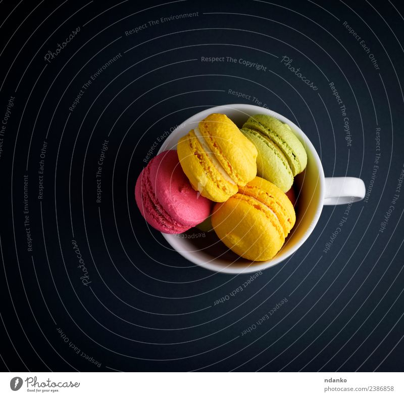 multicolored baked cakes of almond Dessert Candy Bright Blue Yellow Pink Black White Colour Macaron cup mug background food colorful Vanilla french