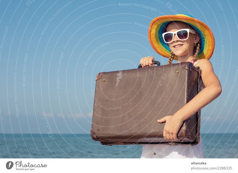 One happy little girl with suitcase standing on the beach. Lifestyle Joy Happy Relaxation Leisure and hobbies Playing Vacation & Travel Tourism Trip Adventure