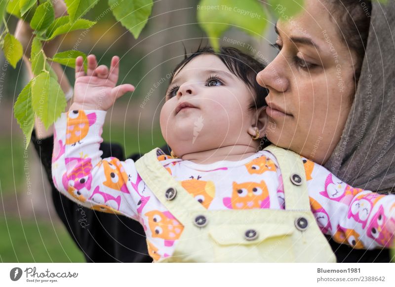 Little baby is exploring and touching new spring leaves in her mother's hug Beautiful Life Relaxation Child Human being Baby Woman Adults Parents Mother