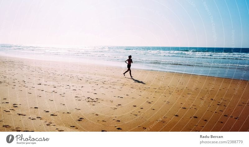 Aerial View Of Sportive Woman Running On Beach Healthy Athletic Fitness Life Adventure Summer Sun Ocean Sports Sports Training Track and Field Jogging