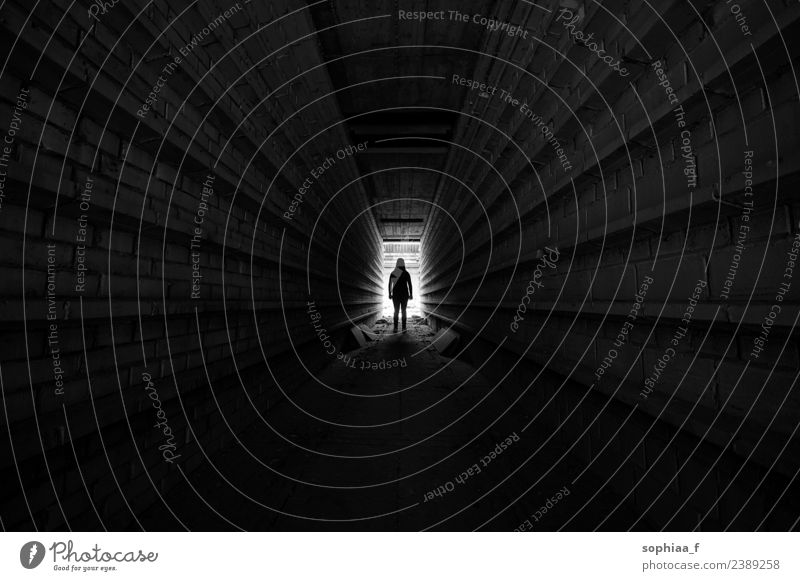 Person standing in light at the end of tunnel, silhouette depression darkness lonely fear mental illness alone isolation underground Power woman Human being