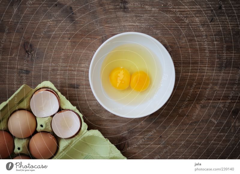 Do you like an omelet? Food Egg Nutrition Organic produce Crockery Bowl Simple Delicious Yolk 2 Eggshell Eggs cardboard Wooden table Colour photo Interior shot
