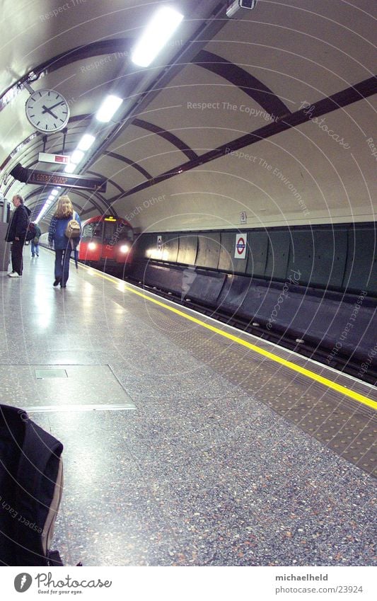 London Underground 3 Platform Neon light Light Clock In transit Transport arriving train Human being Passenger