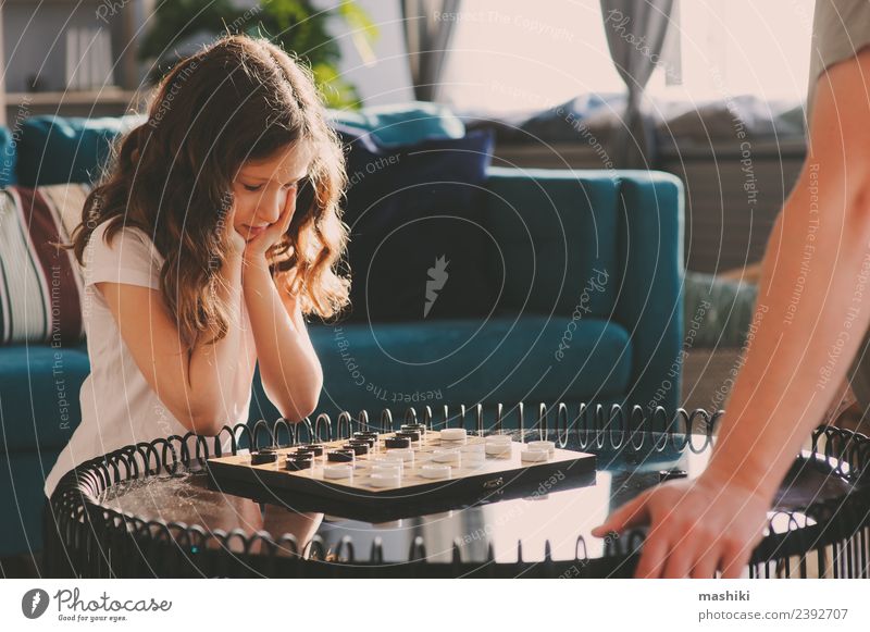child girl playing checkers with her dad Lifestyle Leisure and hobbies Playing Chess Success Child Parents Adults Father Family & Relations Infancy Toys Think