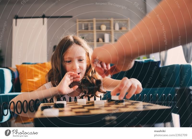 child girl playing checkers with dad Lifestyle Leisure and hobbies Playing Chess Success Child Parents Adults Father Family & Relations Infancy Toys Think