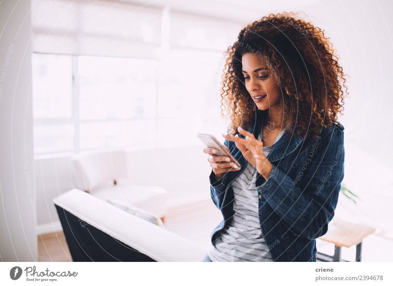 smiling young woman typing a message on cellphone Lifestyle Happy Beautiful Business To talk Telephone Technology Human being Woman Adults Smiling Modern