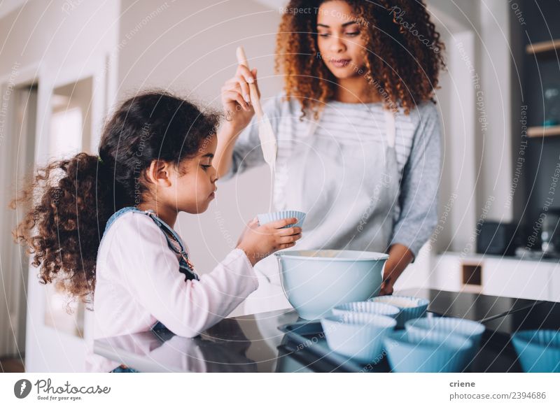mother and daughter baking cupcakes in kitchen together Dessert Bowl Lifestyle Happy Kitchen Child School Woman Adults Family & Relations Together Small cooking