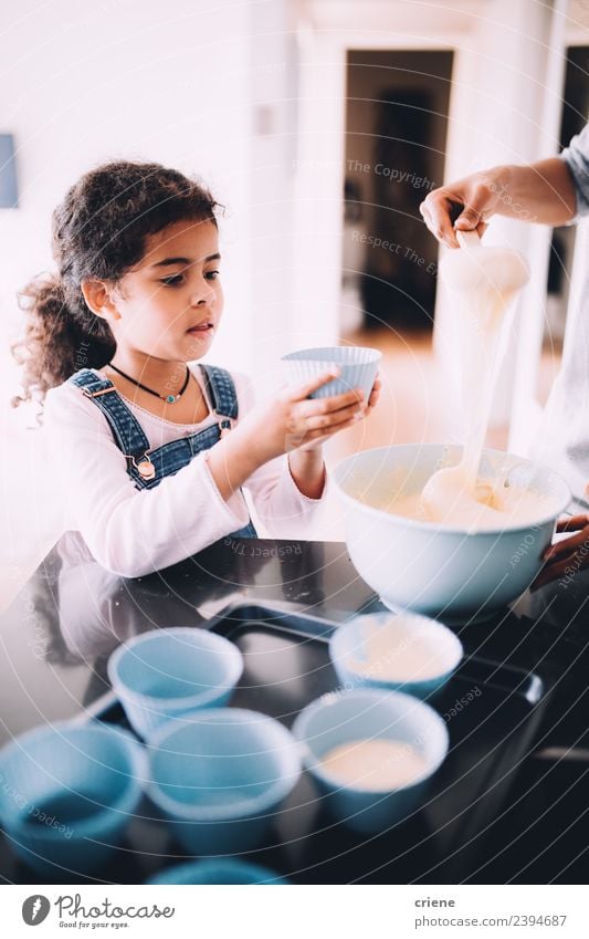 little african girl making cupcakes in kitchen Dessert Bowl Lifestyle Happy Kitchen Child School Woman Adults Small cooking Baking people young Stir food Flour