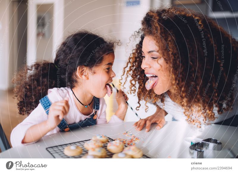 mother and daughter having fun eating cookies together Eating Joy Happy Kitchen Child Woman Adults Mother Family & Relations Infancy Smiling Love Happiness