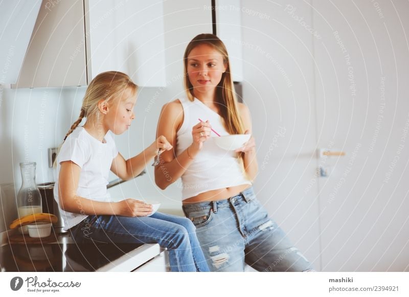 mother having breakfast with daughter Breakfast Lifestyle Joy Happy Kitchen Child Mother Adults Family & Relations Smiling Embrace Together Modern White