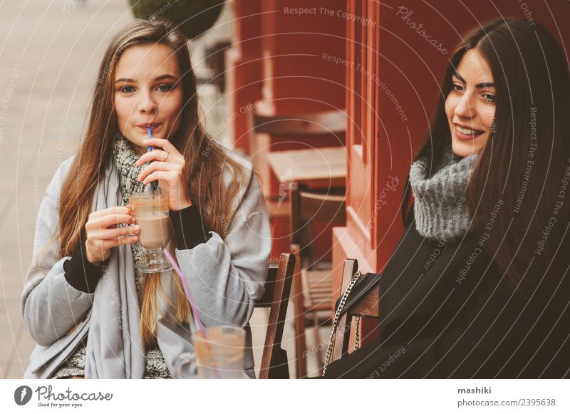 two happy girl friends talking Coffee Lifestyle To talk Feminine Woman Adults Friendship Autumn Street Fashion Coat Smiling Laughter Together Hip & trendy Funny
