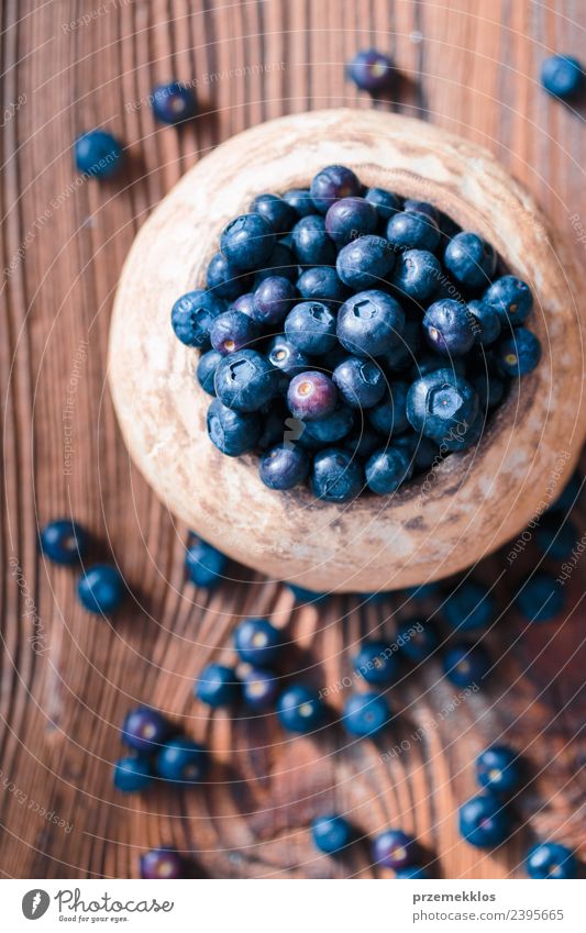 Freshly gathered blueberries put into old ceramic bowl Fruit Nutrition Organic produce Vegetarian diet Diet Bowl Summer Table Nature Wood Authentic Delicious