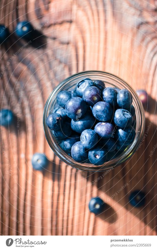 Freshly gathered blueberries put into jar Food Fruit Nutrition Organic produce Vegetarian diet Diet Bowl Summer Table Nature Wood Authentic Delicious Natural