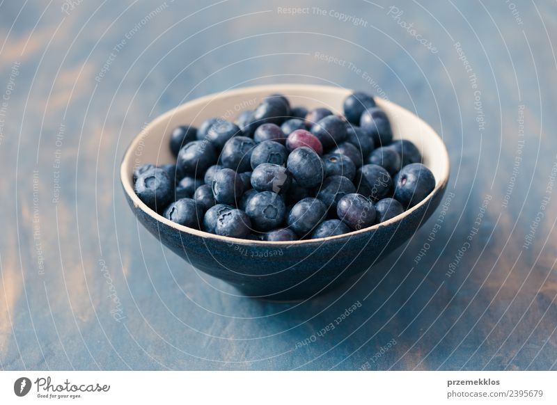 Bowl full of fresh blueberries put on table painted in blue Food Fruit Nutrition Vegetarian diet Summer Table Nature Wood Fresh Delicious Natural Juicy Blue
