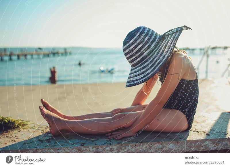 child relaxing on the summer beach Lifestyle Joy Relaxation Vacation & Travel Summer Sun Beach Ocean Child Infancy Hand Warmth Coast Hat Stripe To enjoy Wet
