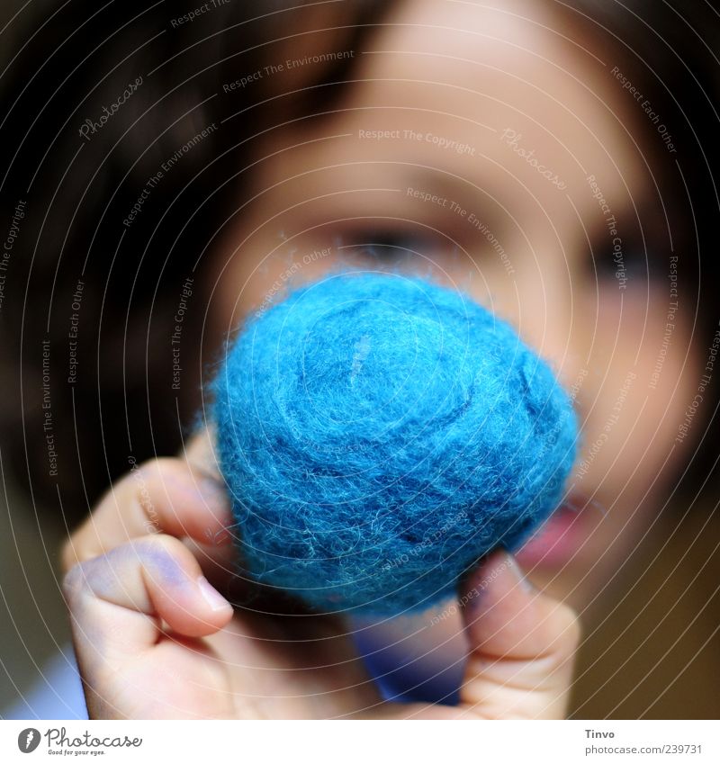 Child holds blue felt ball in his hand Handcrafts Face Fingers 8 - 13 years Infancy Art Blue Felt Textiles Wool Sphere Round Retentive Earth Knot Ball of wool