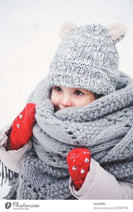 Cute Baby Girl In Knitted Scarf Walking In Winter A Royalty Free