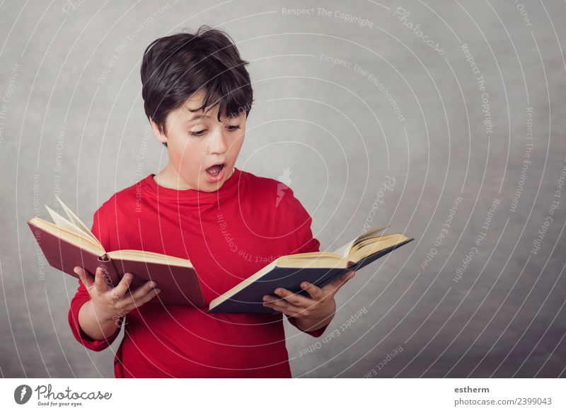 boy reading books on gray background Lifestyle Joy Reading Education Study Schoolchild Examinations and Tests Human being Masculine Child Boy (child) Infancy 1