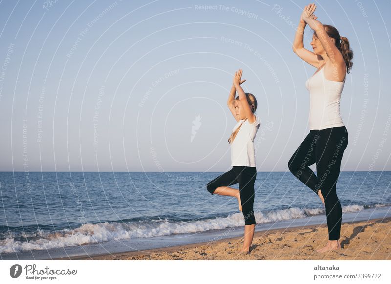 https://www.photocase.com/photos/2399722-mother-and-daughter-doing-yoga-exercises-on-the-beach-dot-photocase-stock-photo-large.jpeg