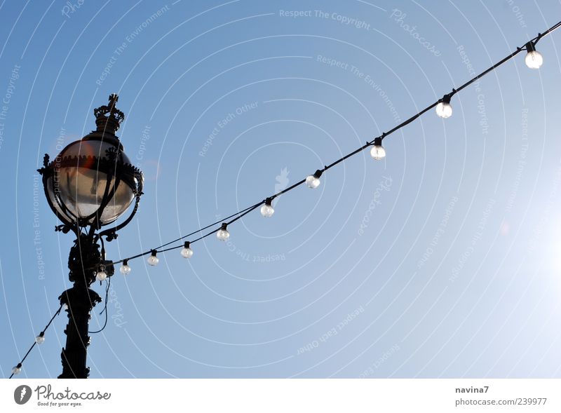 light chain Lamp Cable Cloudless sky Illuminate Blue Nostalgia Colour photo Exterior shot Deserted Copy Space right Neutral Background Day Electric bulb