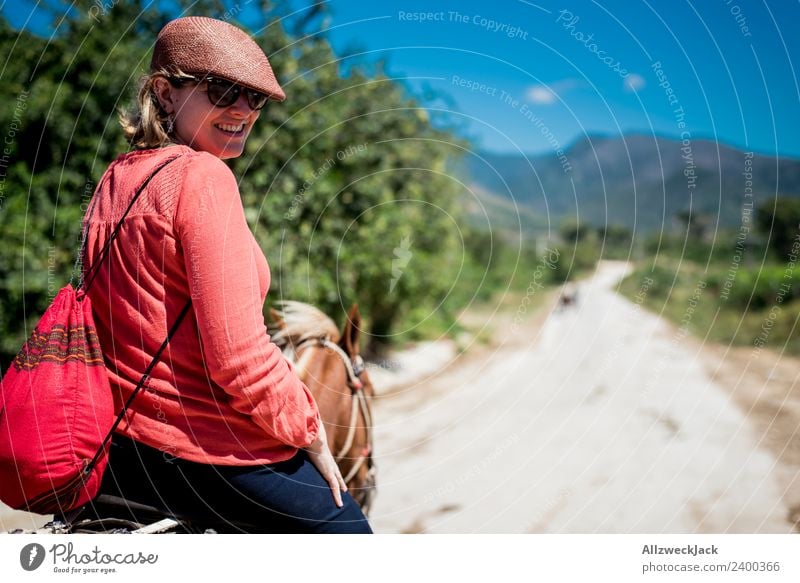young woman with hat rides on horseback through nature in Trinidad Cuba Trinidade Socialism Old Historic Retro Old-school Old fashioned Exterior shot Day Summer