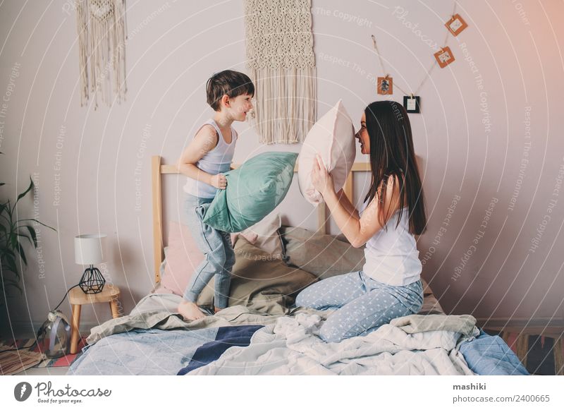 happy mother and child son playing pillow fight Lifestyle Relaxation Bedroom Child Toddler Boy (child) Parents Adults Mother Family & Relations Infancy Smiling