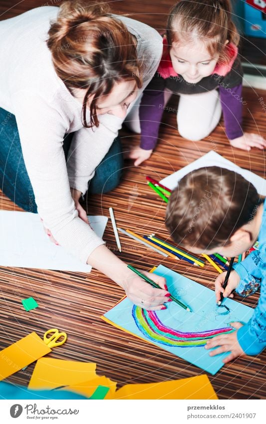 Mom helping her little son drawing a colorful picture Lifestyle Joy Happy Handcrafts Table Parenting Education Kindergarten Child School Craft (trade)