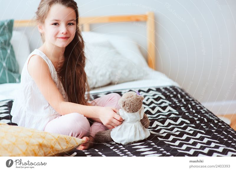 cute happy child girl relaxing at home on the bed Lifestyle Joy Relaxation Bedroom Child Toys Teddy bear Smiling Sleep Dream Small Funny Cute Energy kid Wake up