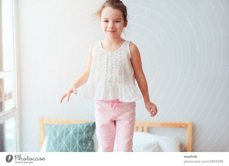 happy kid girl jumping on bed Lifestyle Joy Happy Hair and hairstyles Relaxation Sun Bedroom Child Toys Teddy bear Smiling Sleep Dream Small Funny Cute Energy