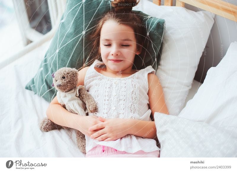 cute little child girl sleeping in comfortable bed. Lifestyle Joy Relaxation Bedroom Child Toys Teddy bear Smiling Sleep Dream Small Funny Cute Energy kid