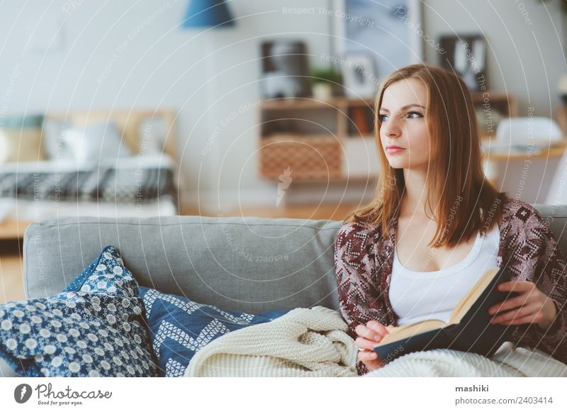 indoor portrait of young thoughtful woman at home Lifestyle Harmonious Relaxation Reading Knit Winter Woman Adults Book Autumn Modern Loneliness Home Cozy calm
