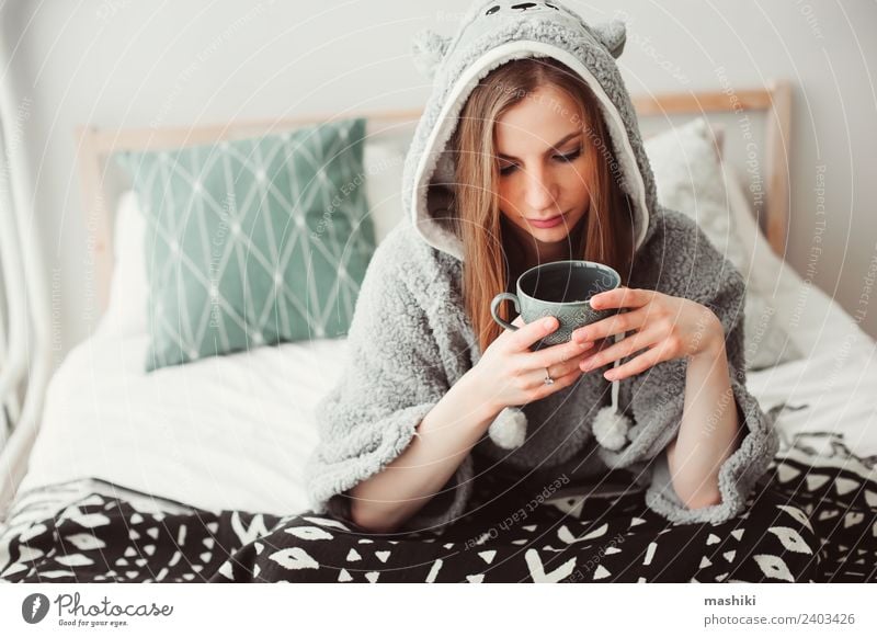 young beautiful woman relaxing at home Coffee Tea Lifestyle Relaxation Bedroom Woman Adults Culture Warmth Fashion Sit Dream Funny Modern Loneliness Considerate