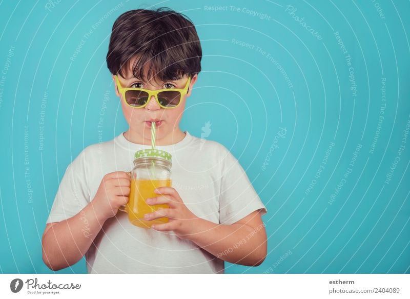 happy boy drinking orange juice on blue background Dessert Nutrition Beverage Drinking Lemonade Juice Lifestyle Joy Wellness Human being Masculine Child Toddler