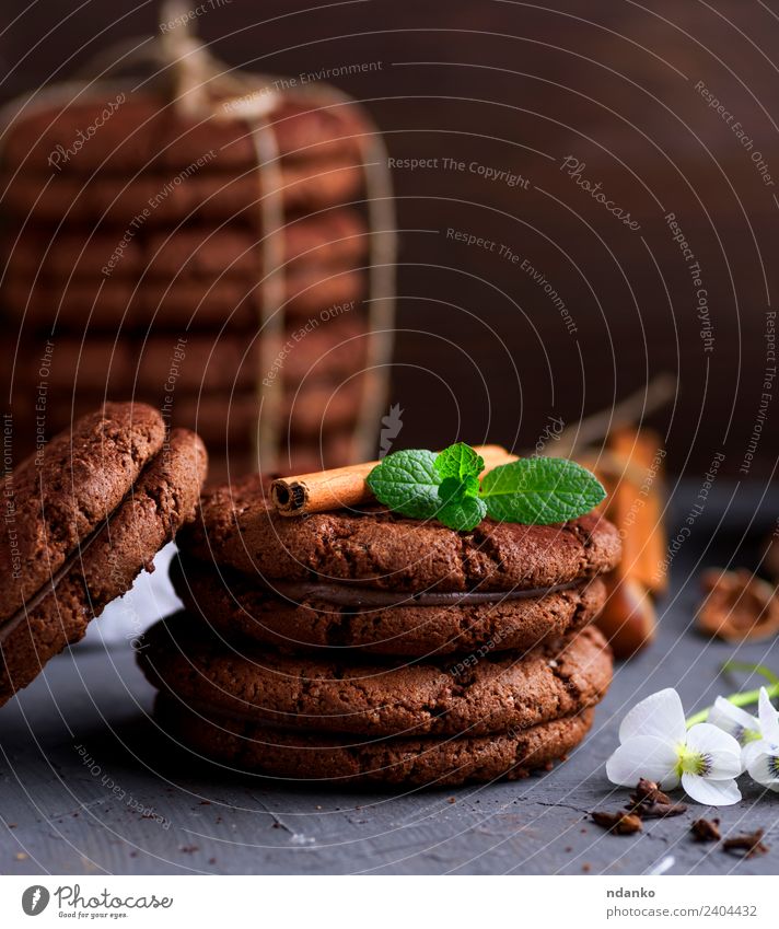 round chocolate cookies Dessert Candy Nutrition Rope Flower Eating Dark Delicious Brown Black background food Stack sweet Baking biscuit holiday Tasty Snack