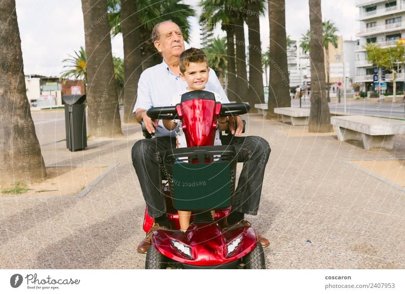 Grandfather and grandson with a electric wheelchair on vacation Summer Chair Child Engines Human being Boy (child) Man Adults Nature Transport Vehicle Old