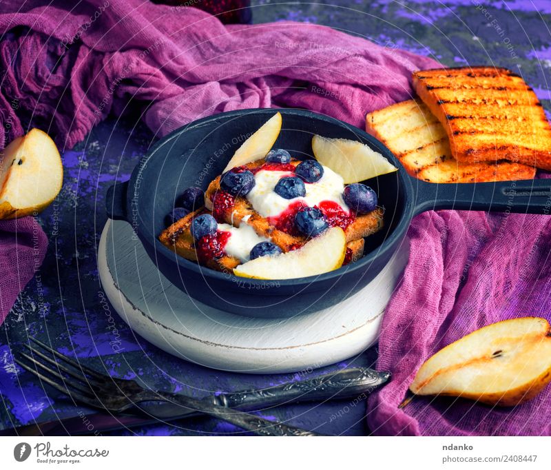 French toast with berries Fruit Bread Dessert Candy Breakfast Lunch Pan Fork Table Fresh Delicious White french cream food background whipped Cast iron vintage