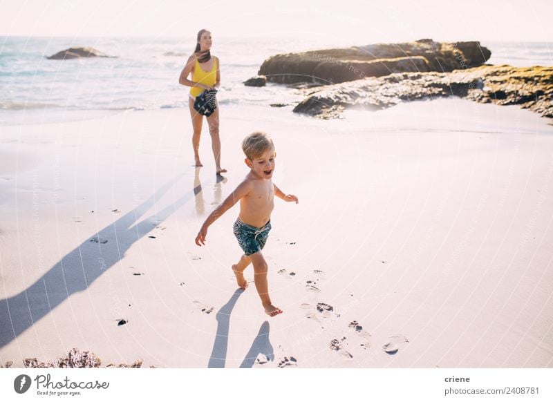 caucasian mother and son walking at the beach close to the water Joy Happy Beautiful Vacation & Travel Summer Sun Beach Ocean Child Woman Adults Mother Nature