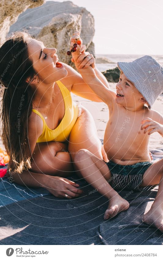 caucasian mother and sun are sharing fruits at the beach Fruit Nutrition Happy Summer Beach Ocean Child Toddler Woman Adults Mother Family & Relations Sand