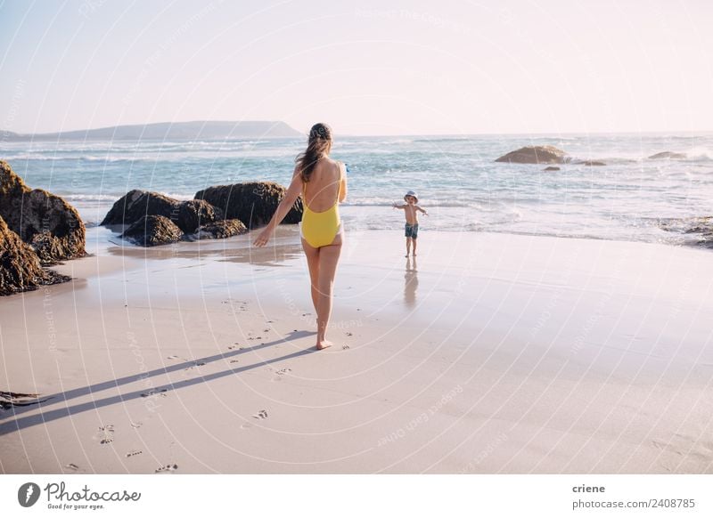 caucasian mother and sun are walking into the water at the beach Lifestyle Happy Relaxation Playing Vacation & Travel Summer Sun Beach Ocean Child Human being