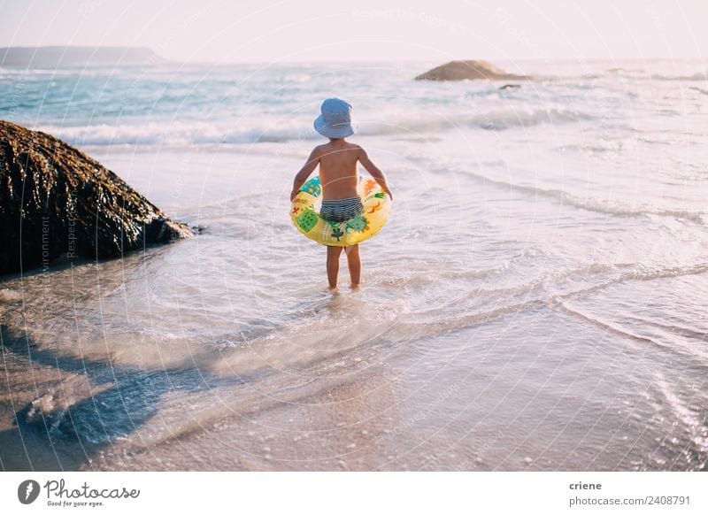 little caucasian boy at the beach with his inflatable ring Joy Happy Beautiful Leisure and hobbies Playing Vacation & Travel Summer Sun Beach Ocean Child