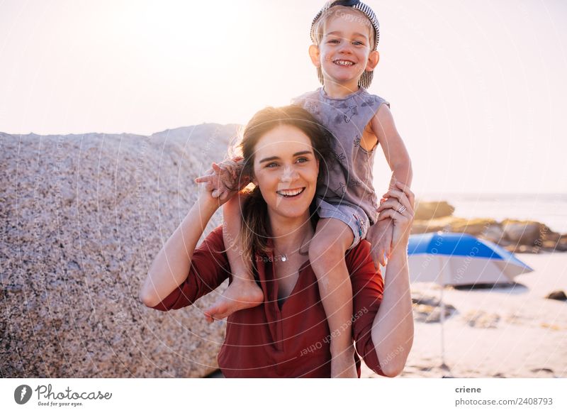 caucasian mother having his son on her back at the beach Lifestyle Style Joy Happy Playing Summer Sun Beach Child Boy (child) Woman Adults Mother